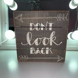 “Don’t look back” wooden sign